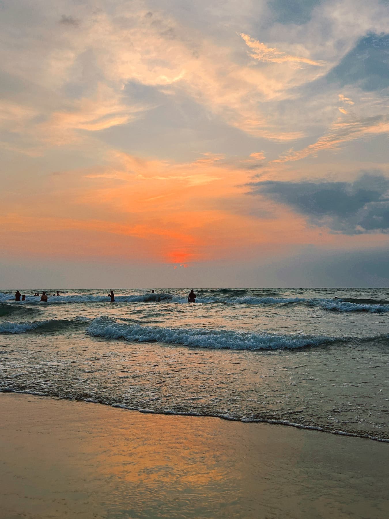 Atardecer con siluetas de personas en la playa de Coveñas