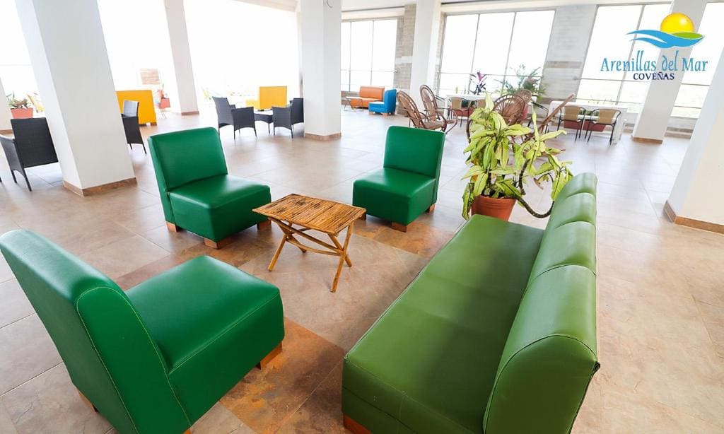 Sala lounge interior del Condominio Arenillas del Mar con sillones verdes